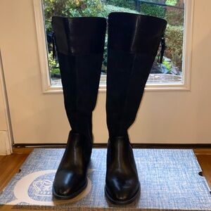 Black suede/leather combo below the knee boots .